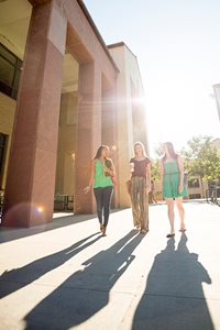 Three business students take a walk through campus