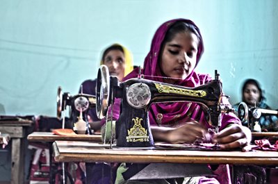 Young garment workers sew fabric in Bangladesh