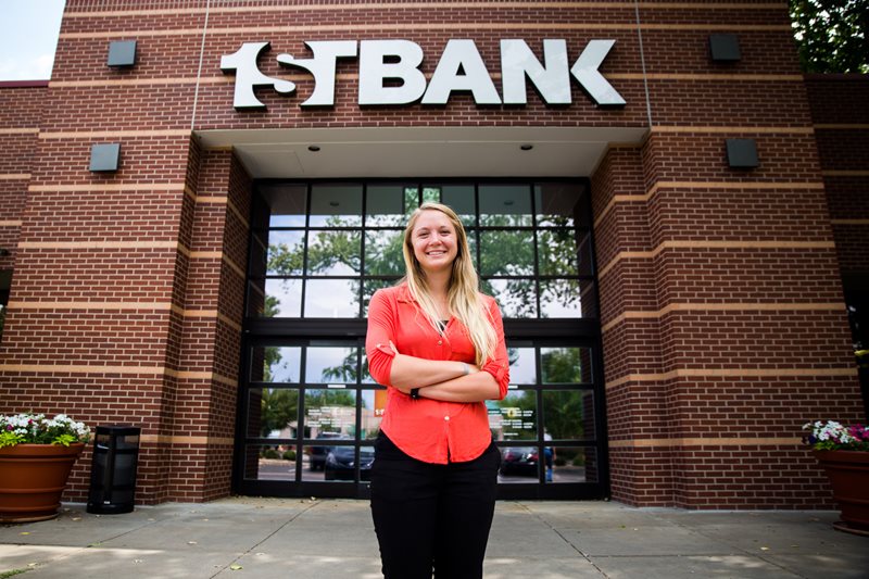 Addie stands in front of FirstBank
